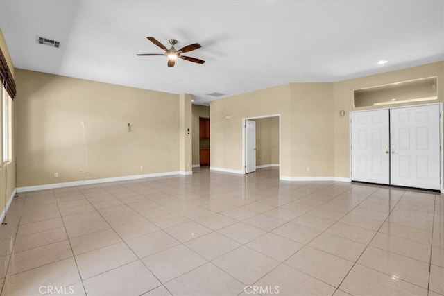 tiled empty room with ceiling fan