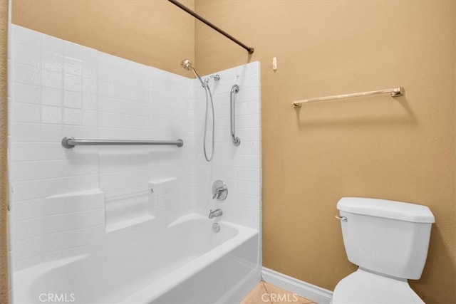 bathroom with washtub / shower combination and toilet