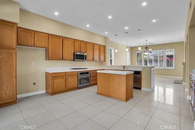 kitchen featuring hanging light fixtures, stainless steel appliances, a center island, light tile patterned flooring, and kitchen peninsula