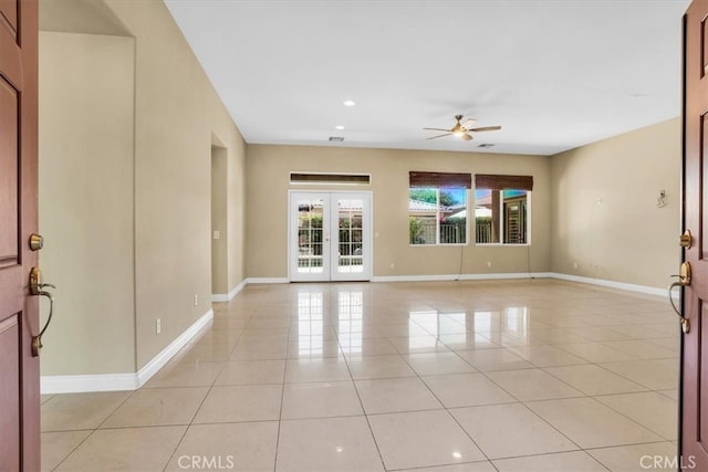 tiled empty room with french doors and ceiling fan