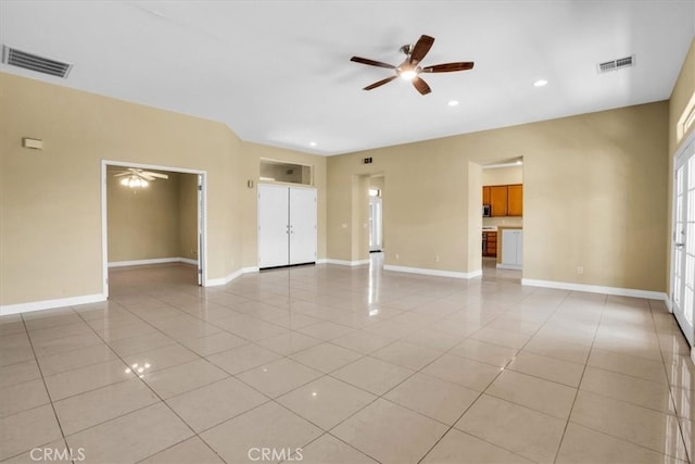 unfurnished living room featuring ceiling fan and light tile patterned flooring