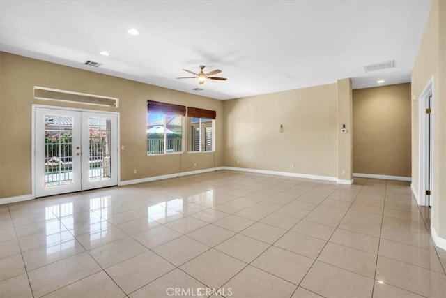 tiled empty room featuring french doors and ceiling fan