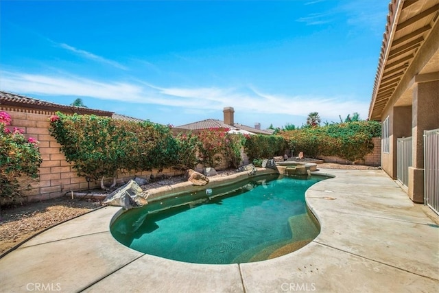 view of pool featuring a patio area and an in ground hot tub