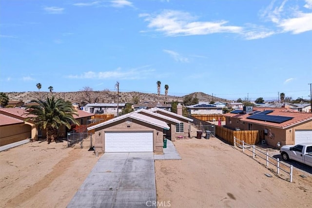 single story home with a garage, driveway, fence, and stucco siding