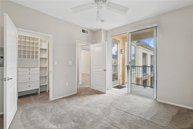 unfurnished bedroom with carpet flooring, access to outside, ceiling fan, and a closet