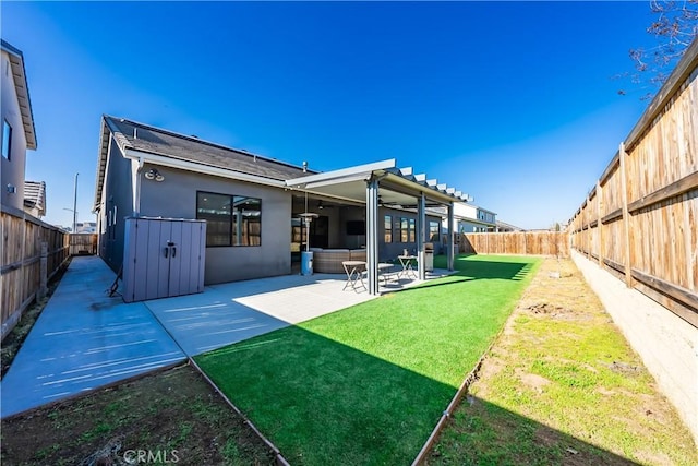 back of house with a lawn and a patio area