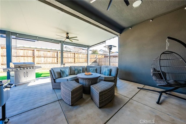 view of patio / terrace with ceiling fan, an outdoor living space with a fire pit, and grilling area