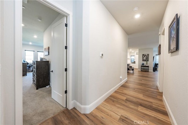 corridor with light hardwood / wood-style floors