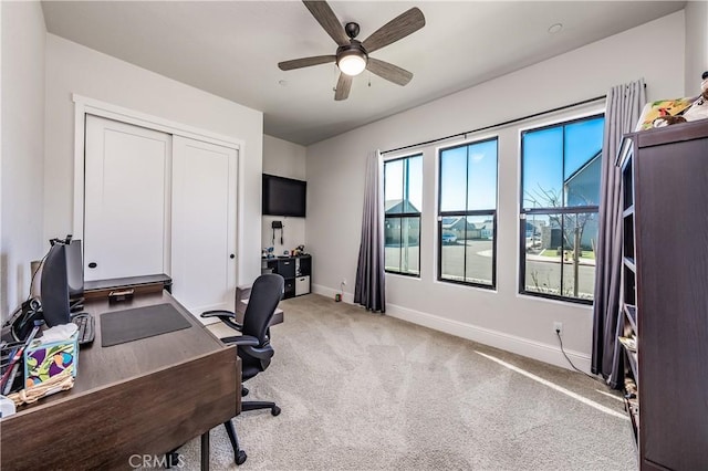 carpeted home office with ceiling fan