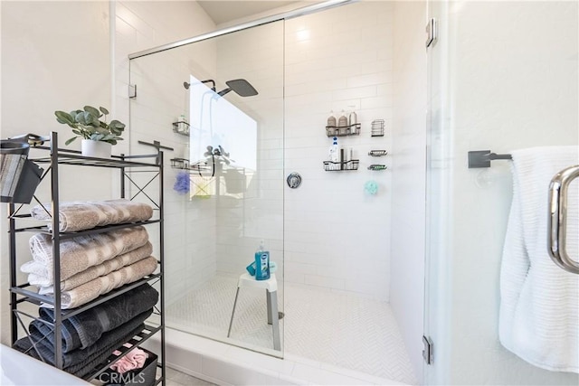 bathroom with a shower with door