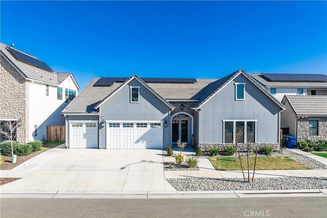 view of front of home with a garage and solar panels