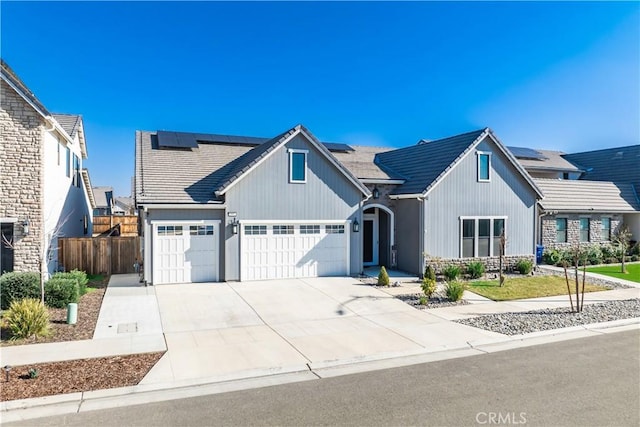 view of front of home with a garage and solar panels