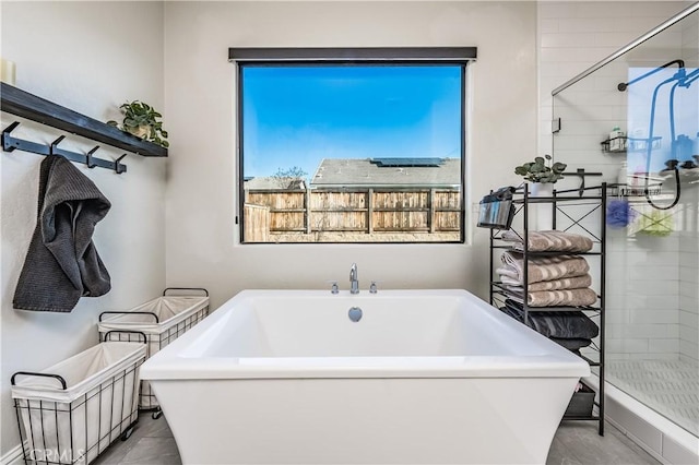 bathroom featuring independent shower and bath