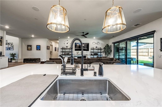 kitchen featuring pendant lighting, sink, and ceiling fan