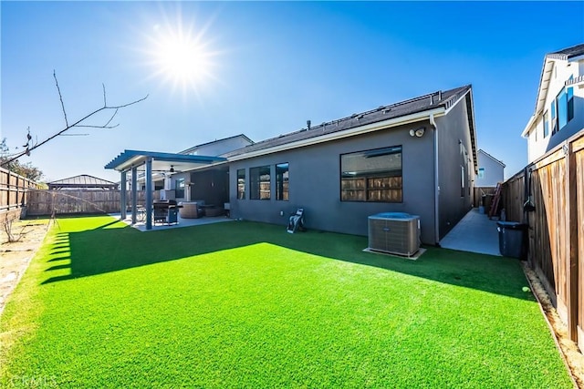 back of property featuring central AC, a patio, and a lawn