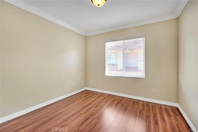 unfurnished room featuring wood-type flooring and crown molding