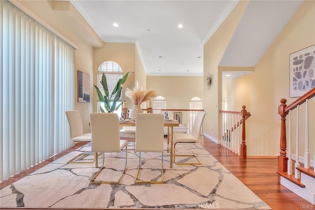 dining area featuring light hardwood / wood-style flooring and ornamental molding