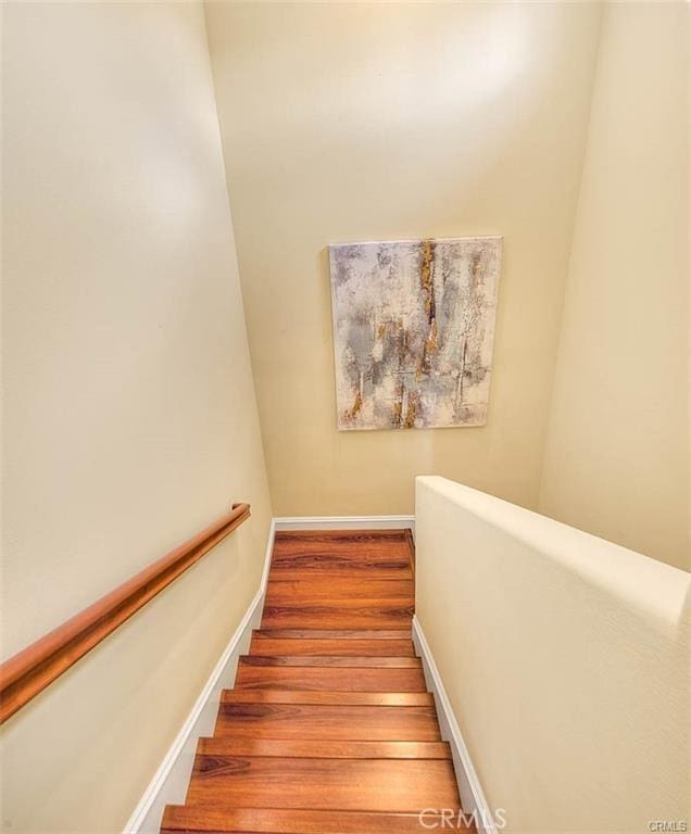 stairway with hardwood / wood-style flooring