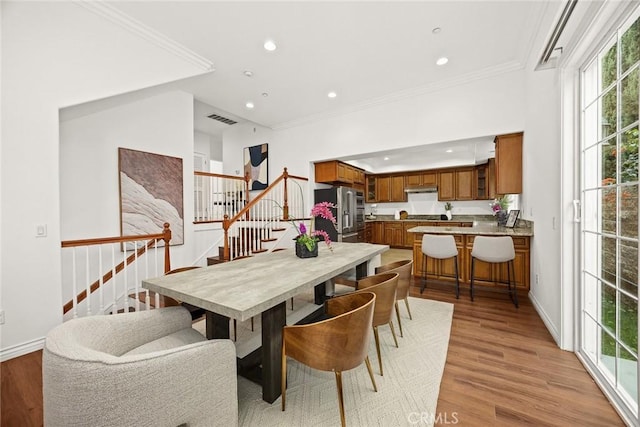 dining room featuring visible vents, recessed lighting, light wood-style floors, and stairway