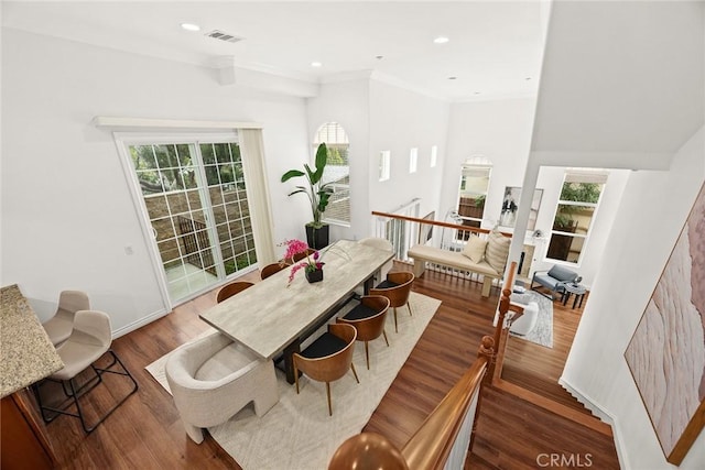 dining space featuring recessed lighting, wood finished floors, visible vents, and ornamental molding