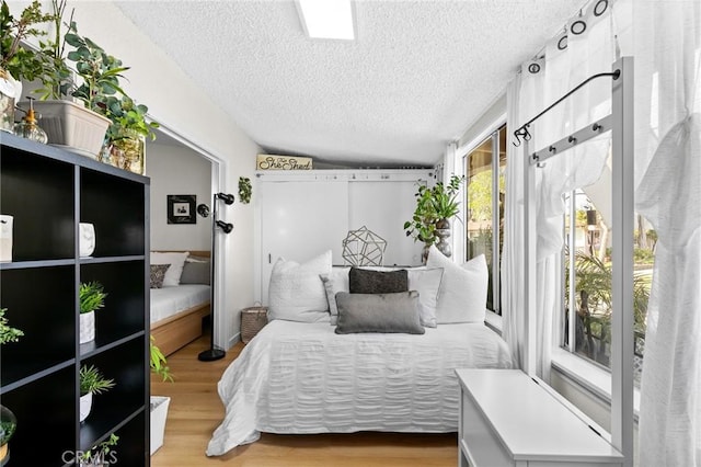 bedroom featuring a textured ceiling and hardwood / wood-style flooring