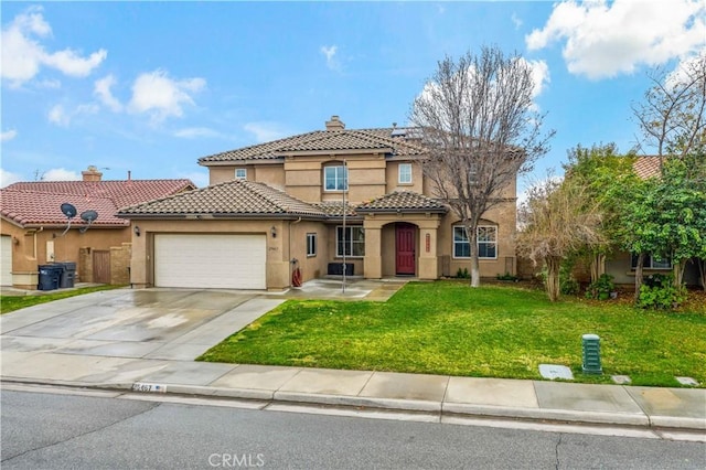 mediterranean / spanish house featuring a garage and a front lawn