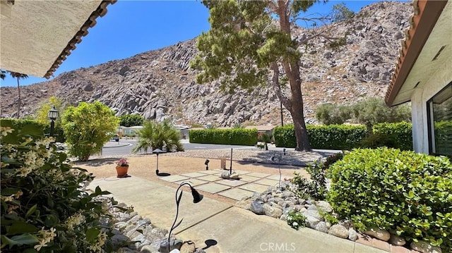 exterior space featuring a mountain view and a patio