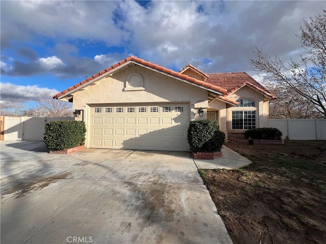 mediterranean / spanish-style home with a garage