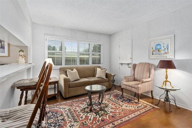 living room featuring hardwood / wood-style flooring and a textured ceiling