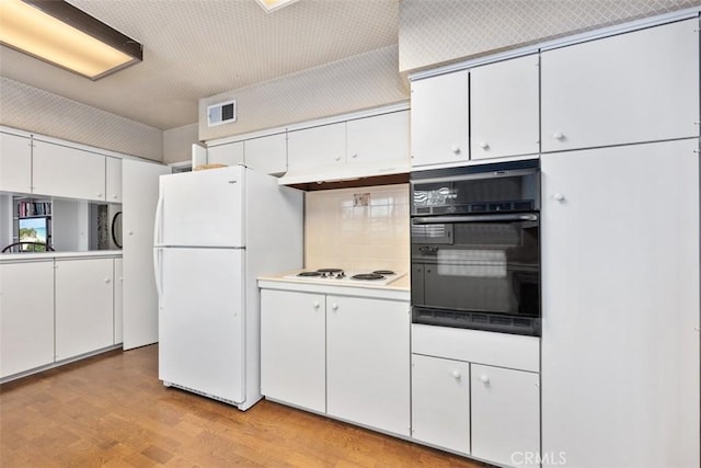 kitchen featuring white cabinetry, white appliances, light hardwood / wood-style floors, and decorative backsplash