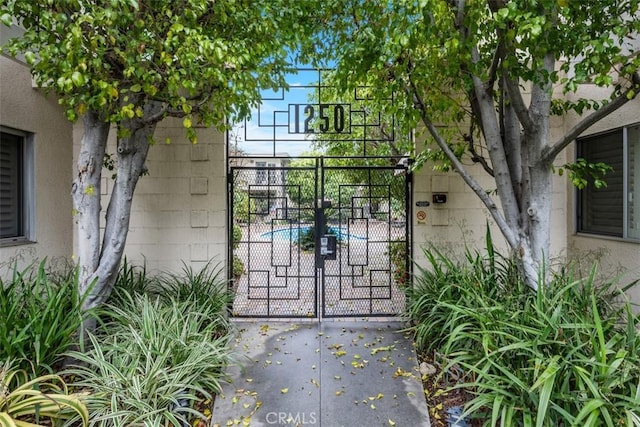 view of gate with a patio area