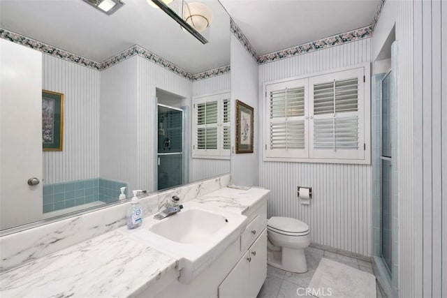 bathroom featuring vanity, toilet, and an enclosed shower