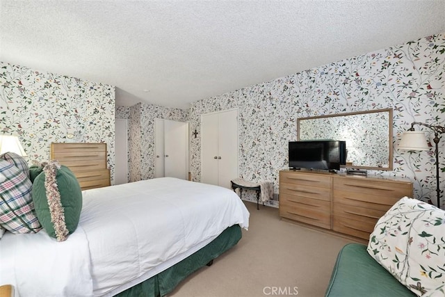 bedroom with carpet flooring and a textured ceiling