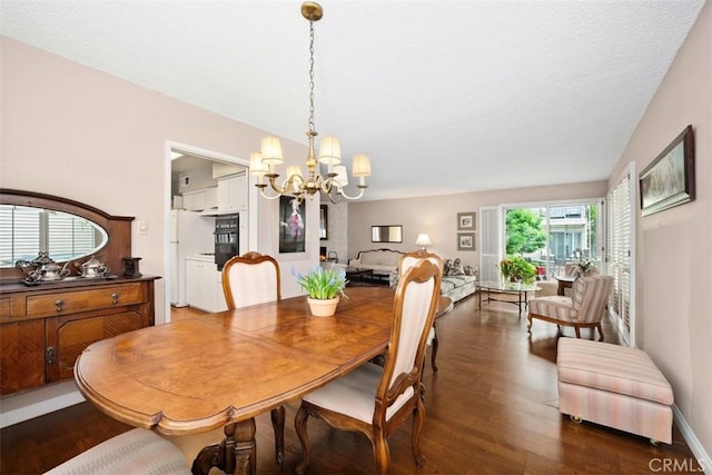 dining area featuring an inviting chandelier and dark hardwood / wood-style floors