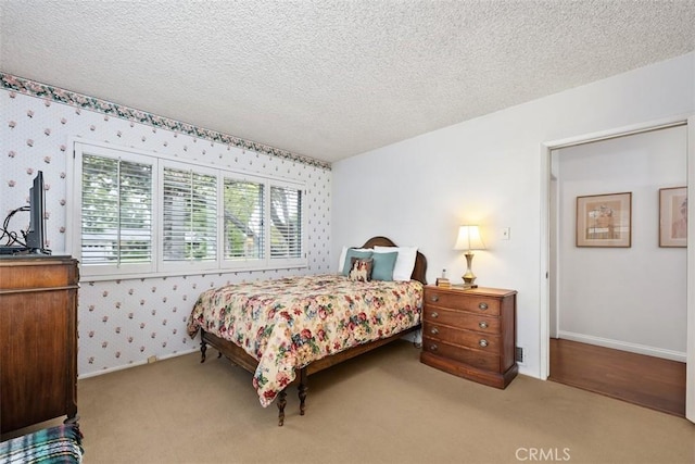 carpeted bedroom featuring a textured ceiling