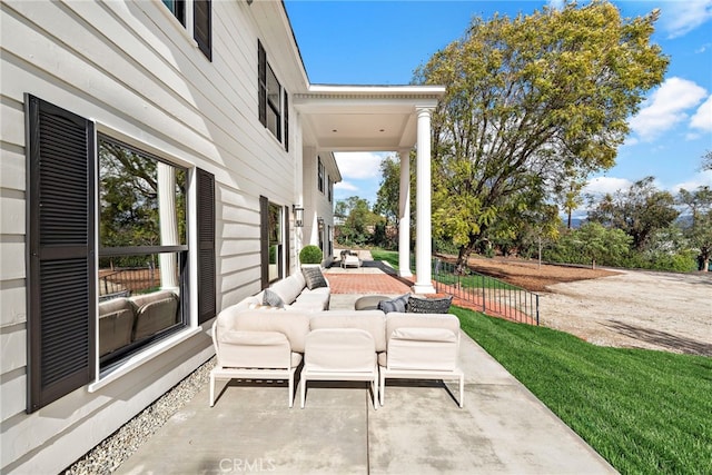 view of patio with an outdoor living space and fence