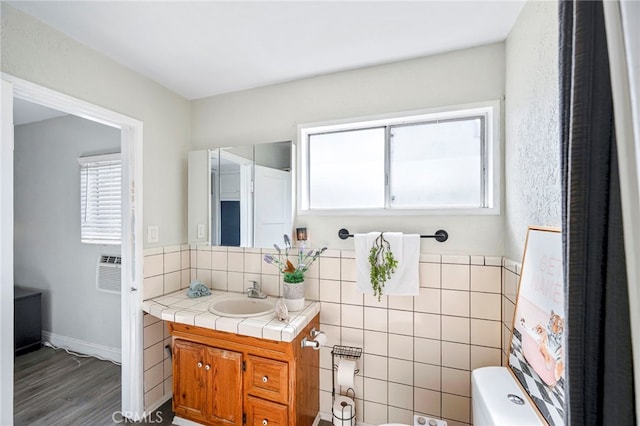 bathroom featuring vanity, toilet, and wood-type flooring