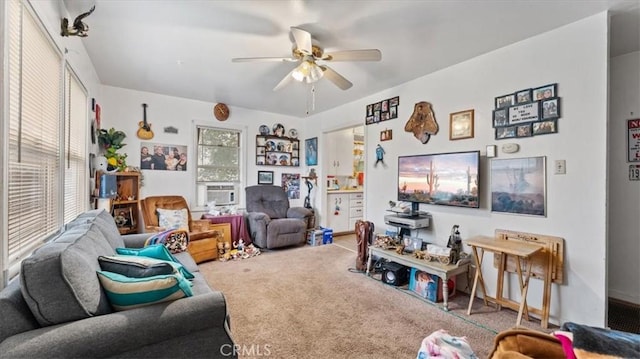 living room featuring ceiling fan and carpet