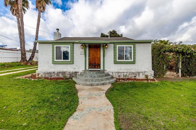 bungalow-style house featuring a front lawn