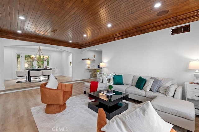 living room with a notable chandelier, ornamental molding, light wood-type flooring, and wooden ceiling