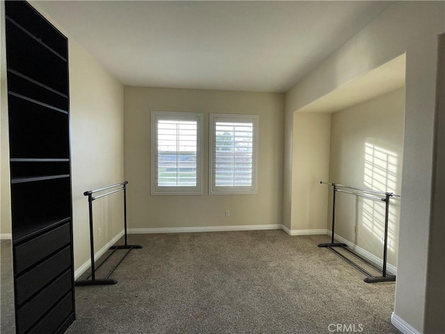 carpeted empty room with baseboards