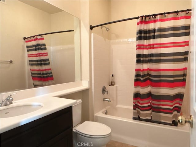 bathroom featuring toilet, shower / bath combo with shower curtain, and vanity