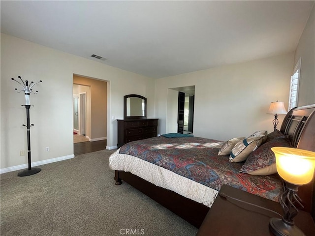 carpeted bedroom featuring visible vents and baseboards