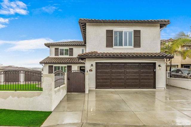 view of front of property with a fenced front yard, a gate, driveway, and stucco siding