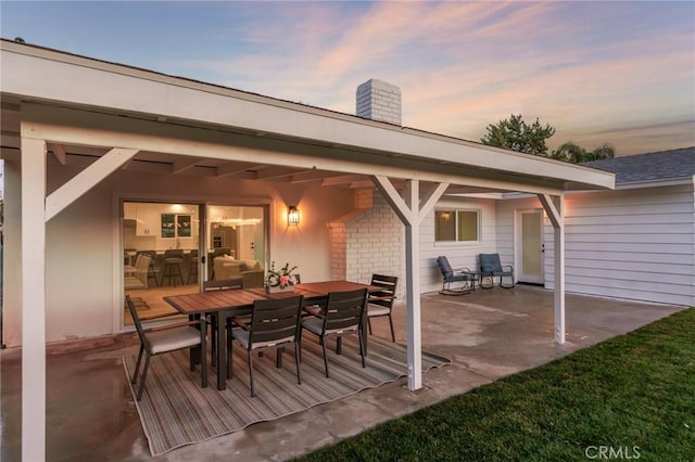 view of patio terrace at dusk