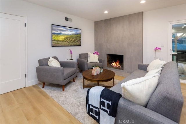 living room featuring hardwood / wood-style flooring and a fireplace