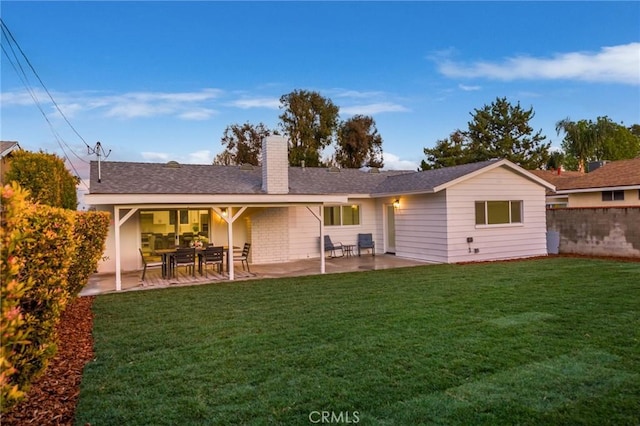 back of house featuring a yard and a patio