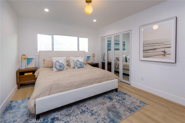 bedroom with light hardwood / wood-style floors and french doors