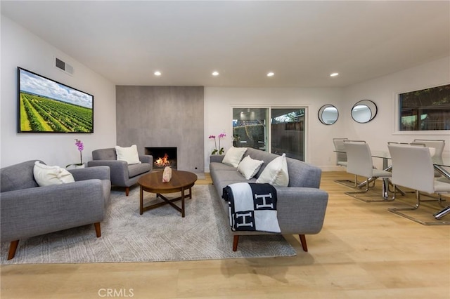 living room featuring a fireplace and light hardwood / wood-style floors