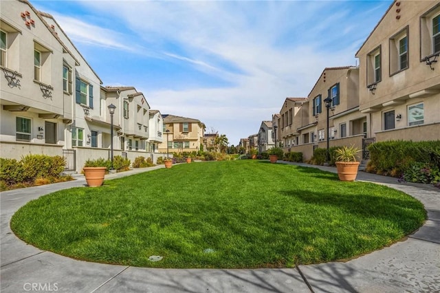 view of property's community with a lawn